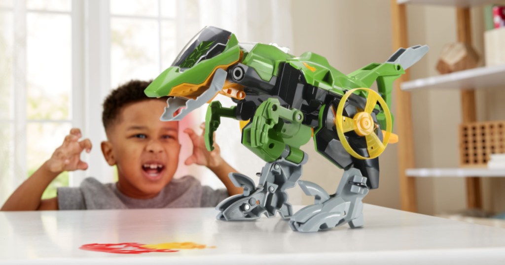 boy playing with dinosaur jet vehicle at table