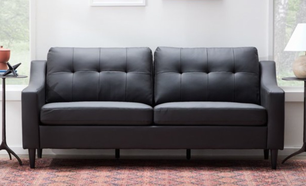 black faux leather couch stock photo