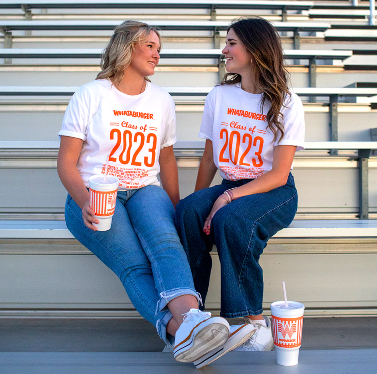 Two girls wearing a Whataburger Class of 2023 Tshirt which is one of our graduation gift ideas