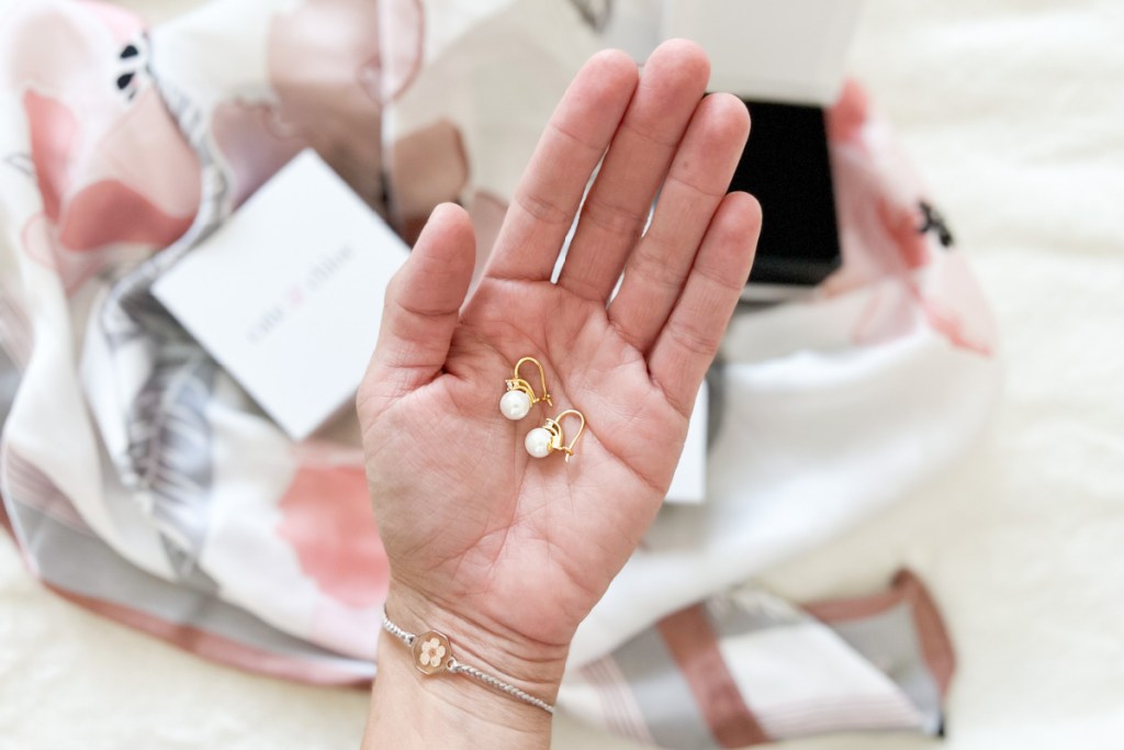 pearl earrings in palm of hand