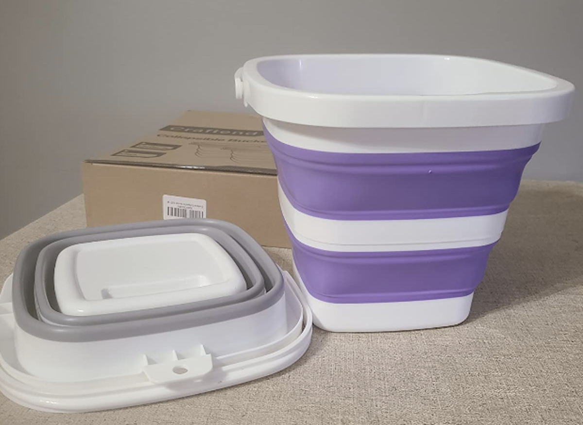 gray and purple collapsible beach buckets on table