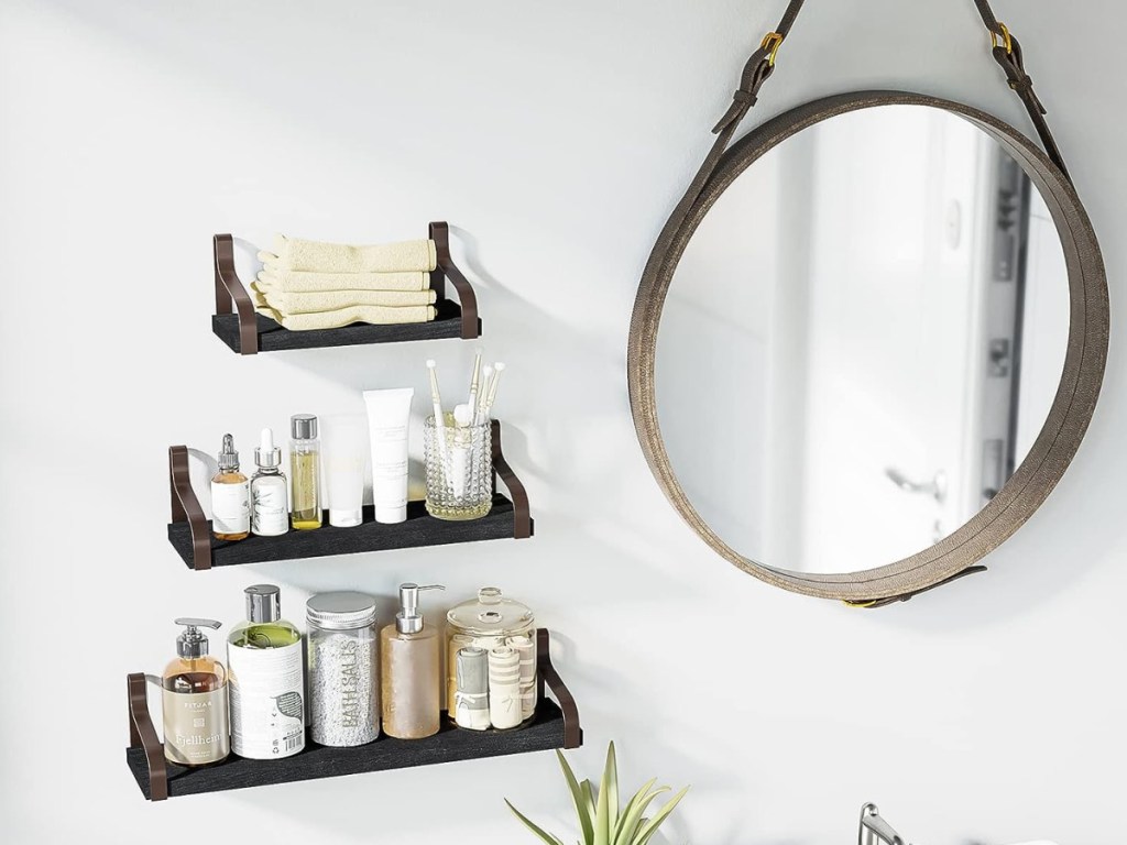 display of three differermmt size shelves in the bathroom next to mirror