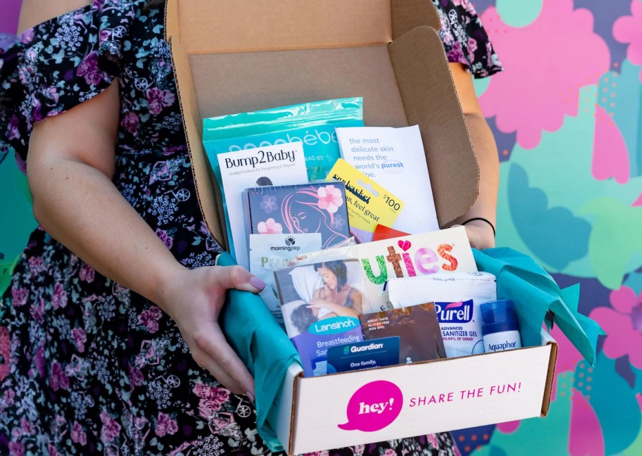 woman holding box of pregnancy and baby freebies