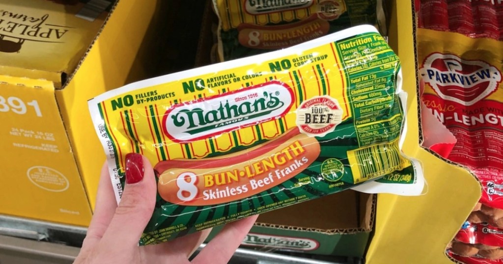 holding a package of Nathan's hot dogs