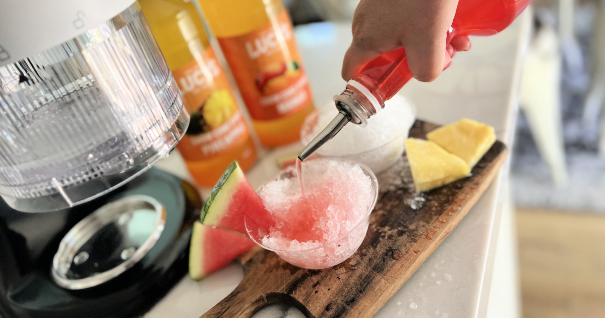 pouring snow cone syrup on shave ice