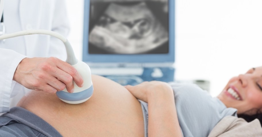 pregnant woman getting sonogram of baby