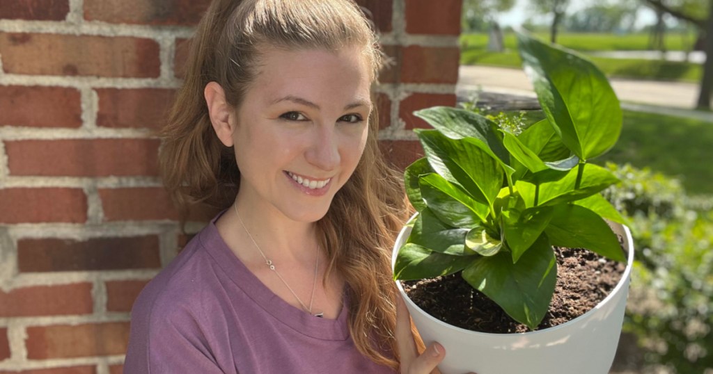 woman holding self-watering planters 