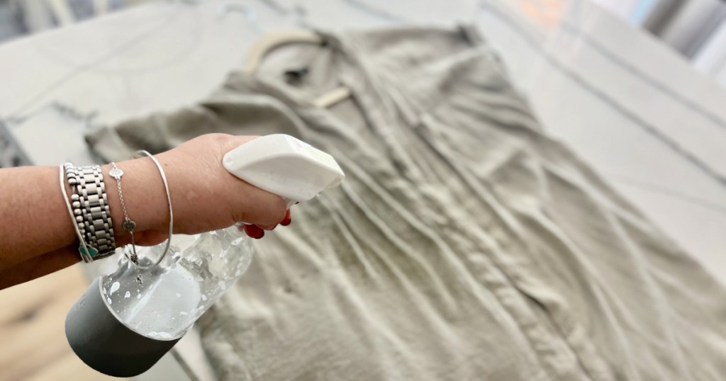 spraying a shirt with diy wrinkle release spray
