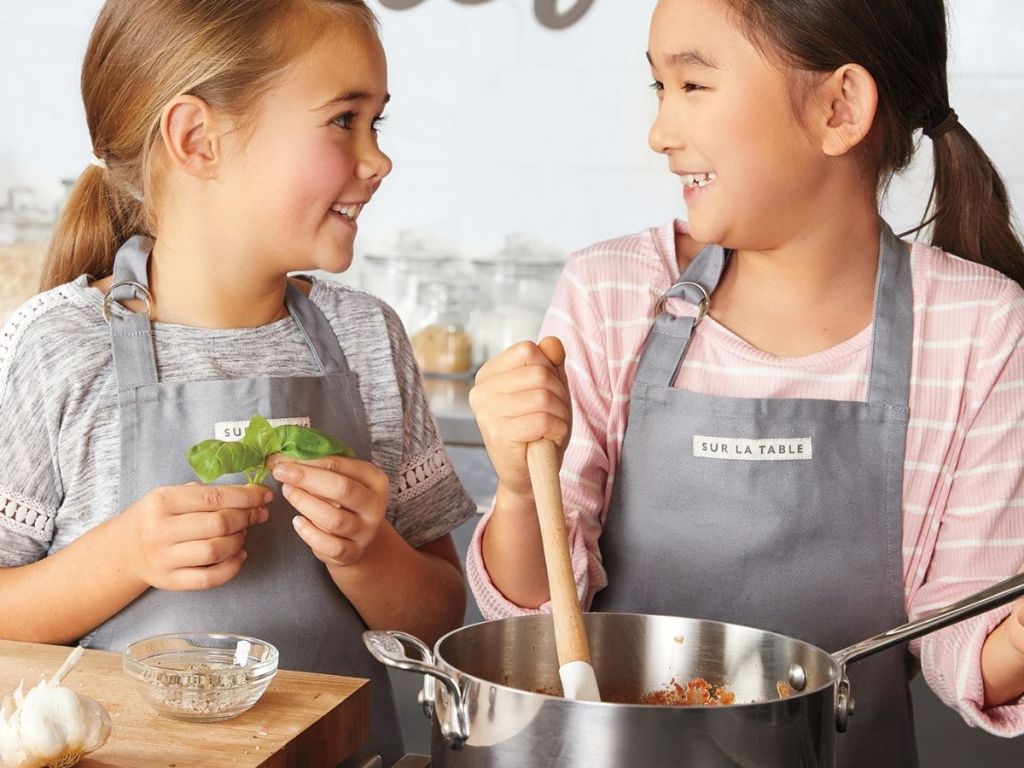 girls wearing aprons cooking