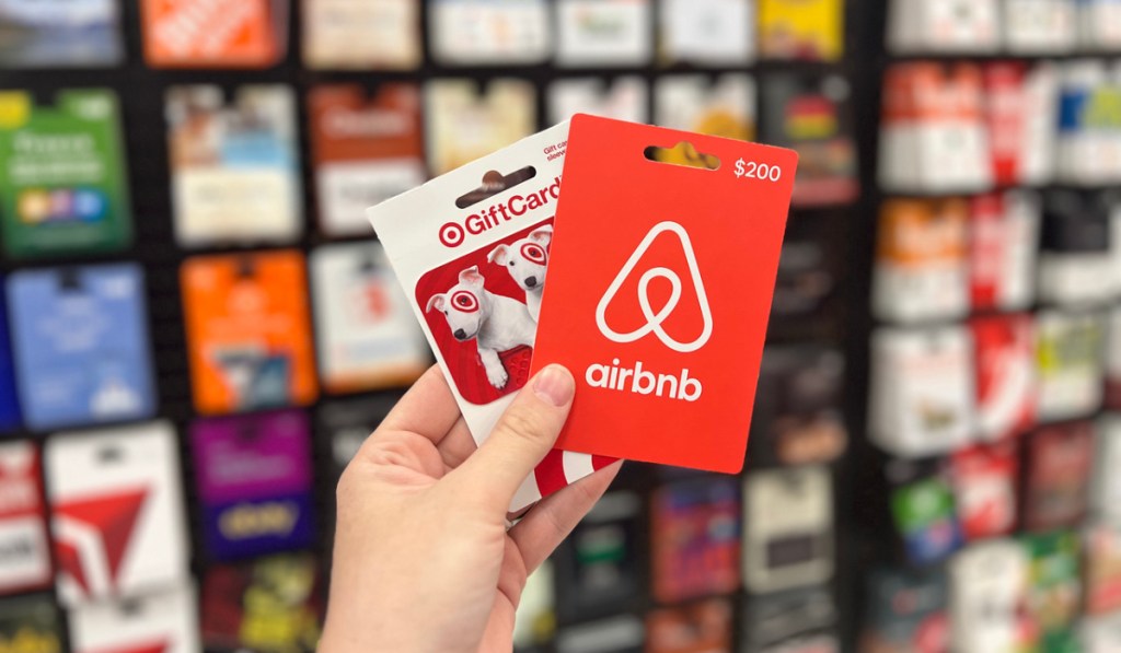 woman holding a target and airbnb gift card