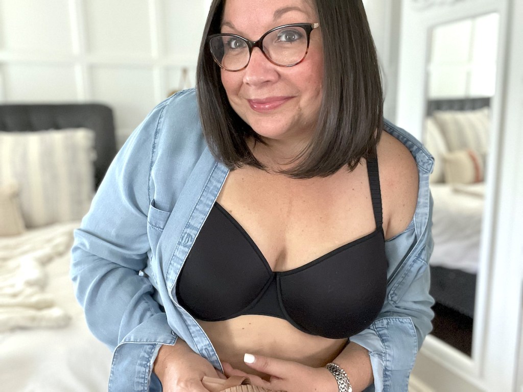 woman smiling wearing black ThirdLove bra and chambray button down shirt