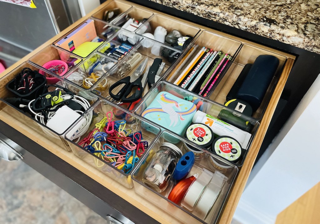 organized junk drawer with the home edit products clear organizing containers
