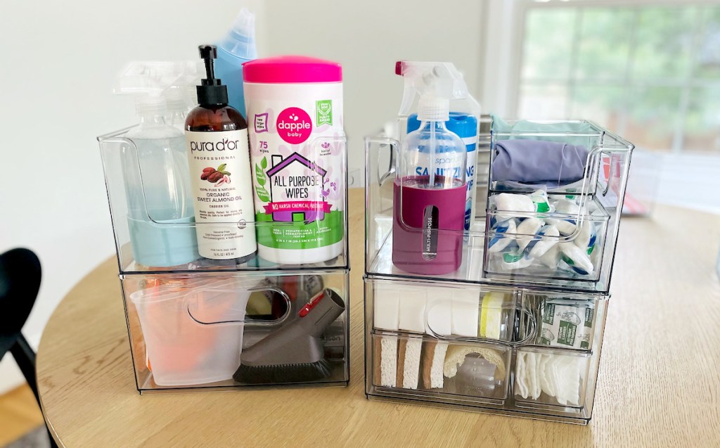 clear storage containers on wood table with organized cleaning products inside