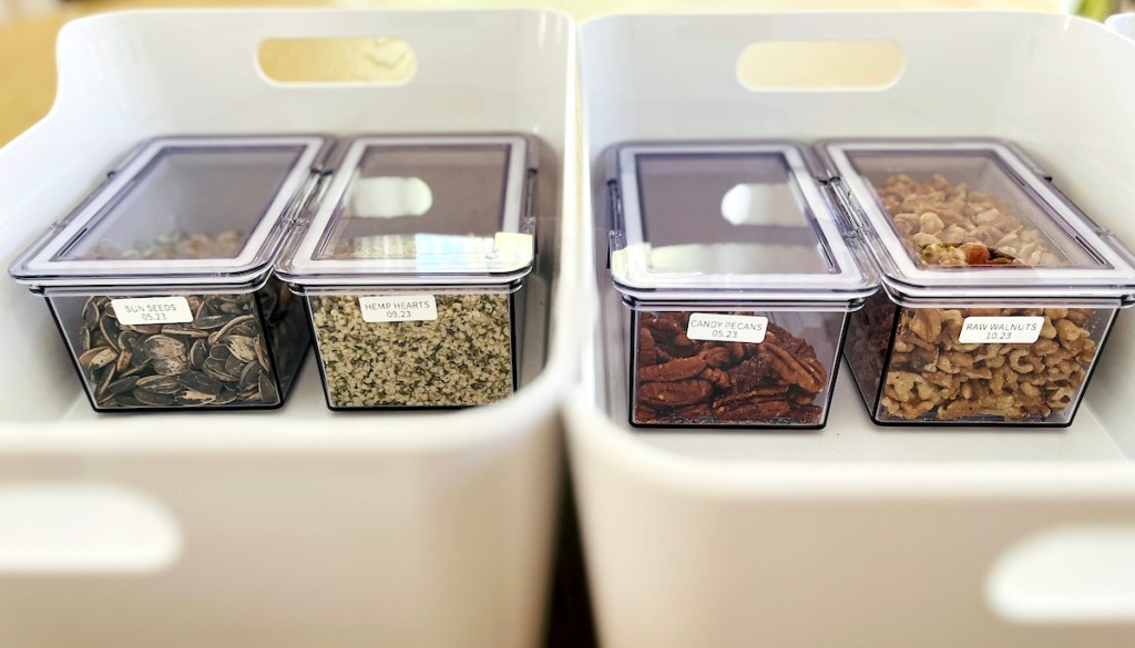 various clear containers of dry pantry food labeled in clear containers