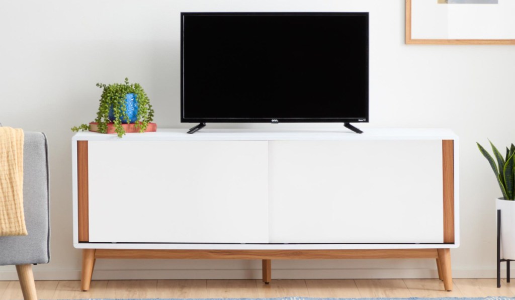 tv on white and oak tv console