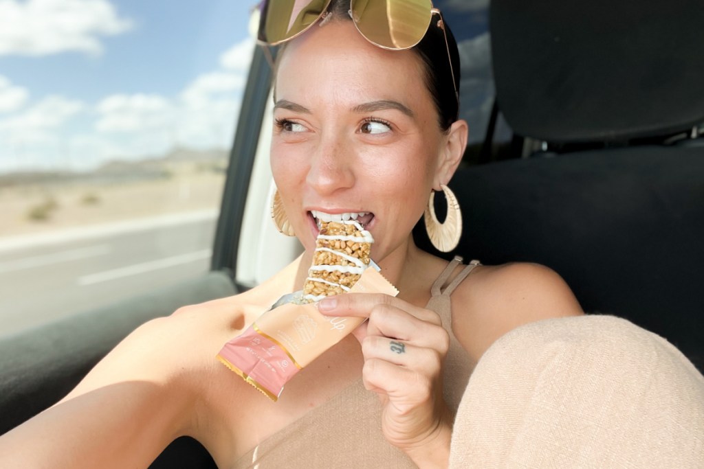 woman in car eating snack