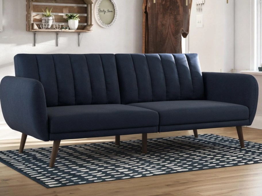 navy blue mid century modern style convertible sofa in a living room