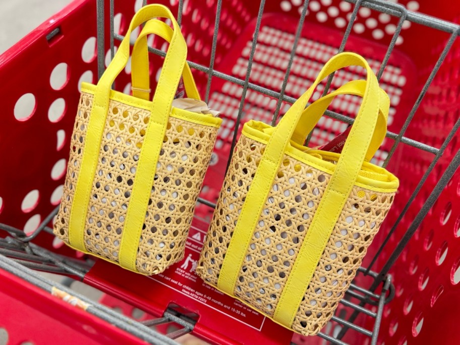 two caning handbags with yellow handles and straps in a Target cart