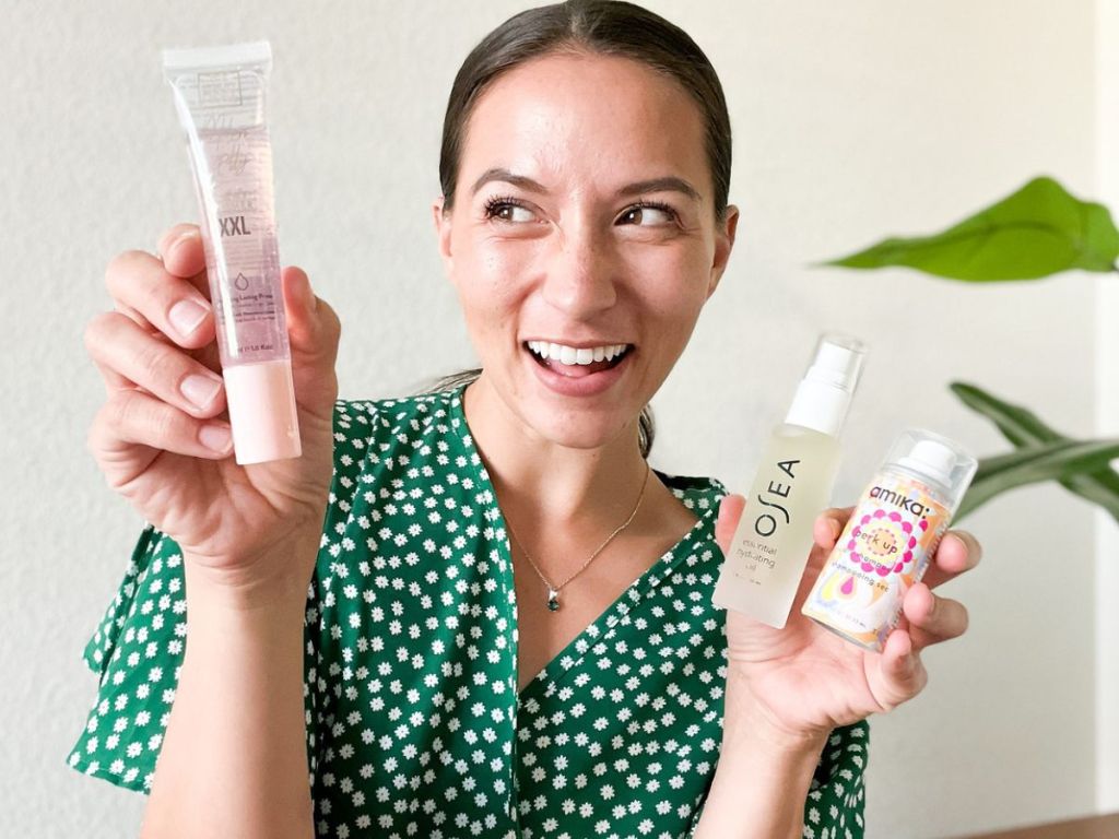 woman holding 3 beauty products