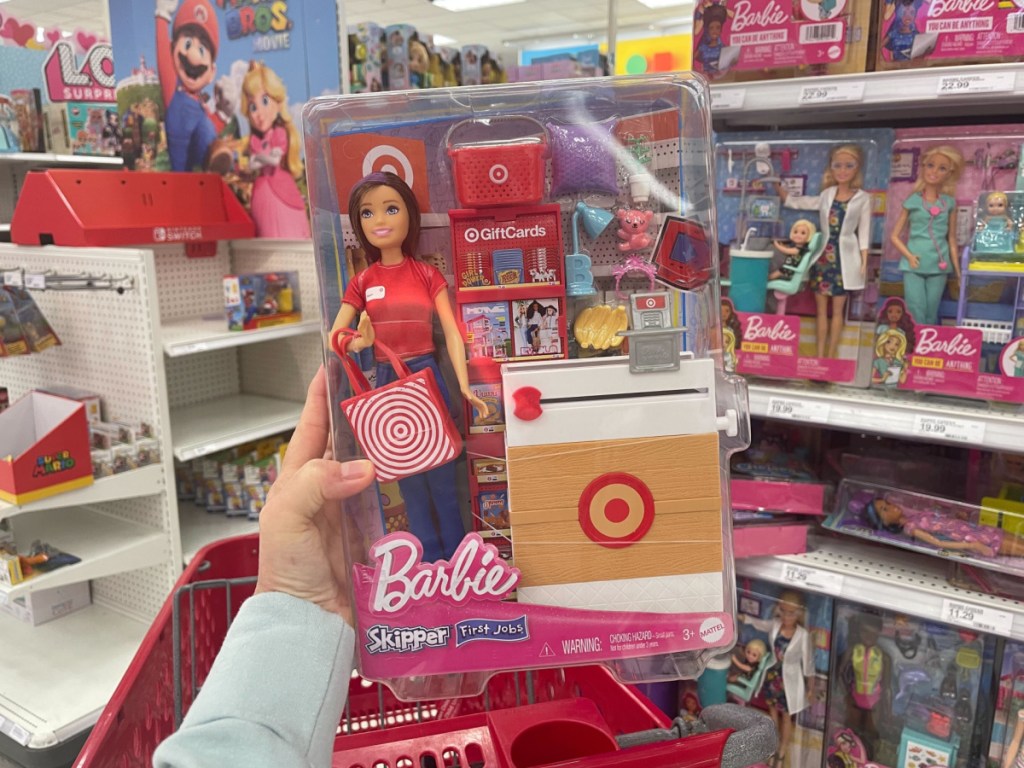 person holding Barbie Skipper First Job Doll inside target store