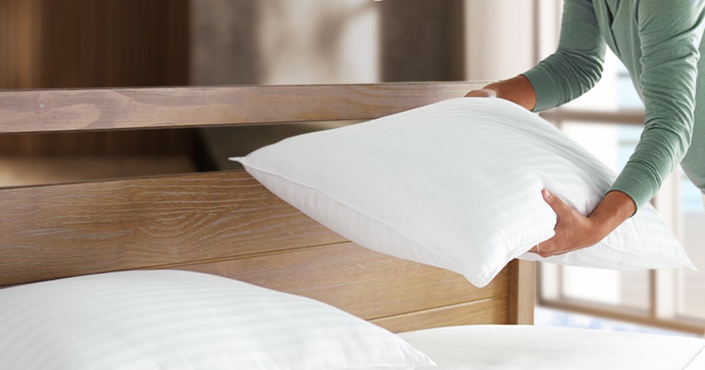 two white pillows on a bed