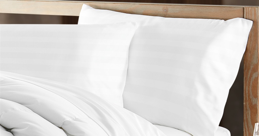 two white pillows on a bed