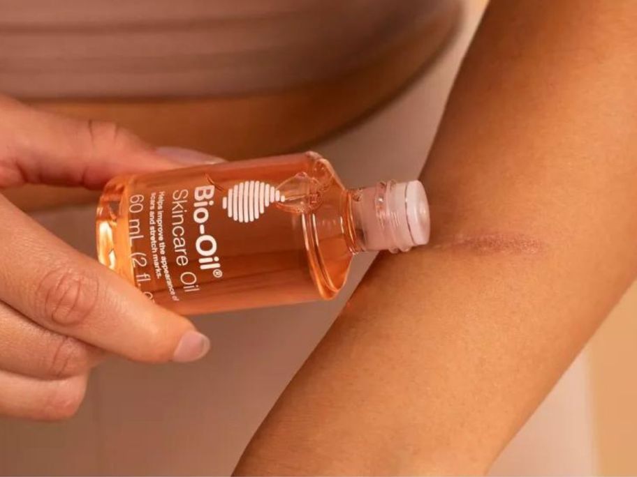 woman putting Bio-Oil Skincare Oil on her arm
