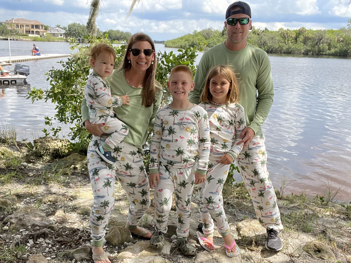 family posing in matching family pajamas