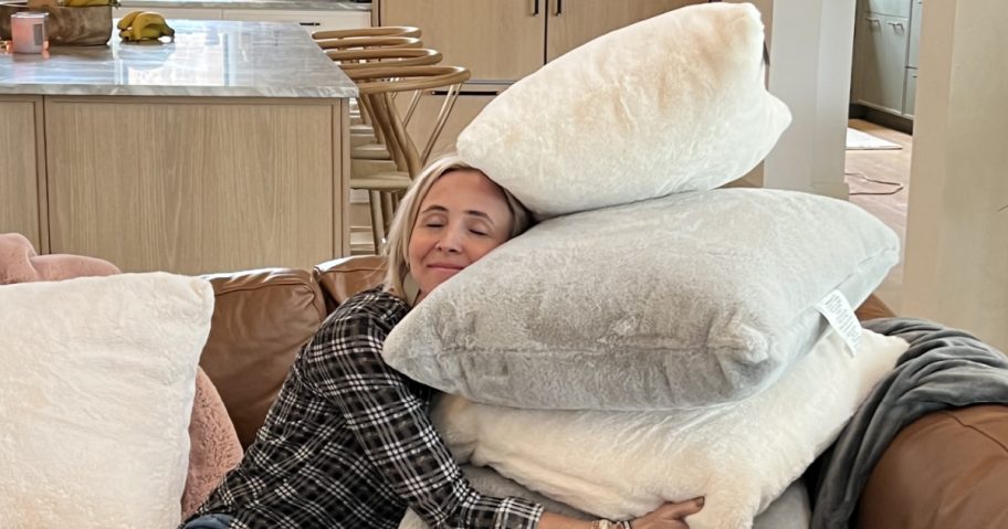 woman hugging throw pillows