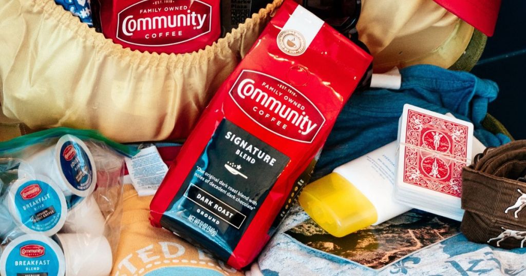 Bag of Community Coffee Signature Blend in a suitcase with travel essentials