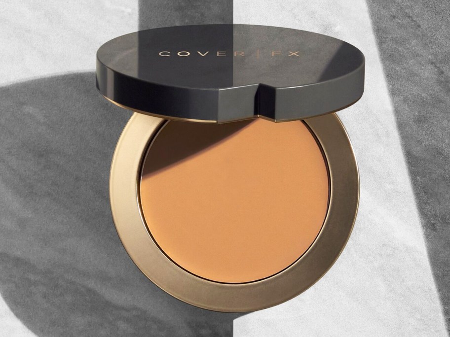 opened compact of cream foundation 