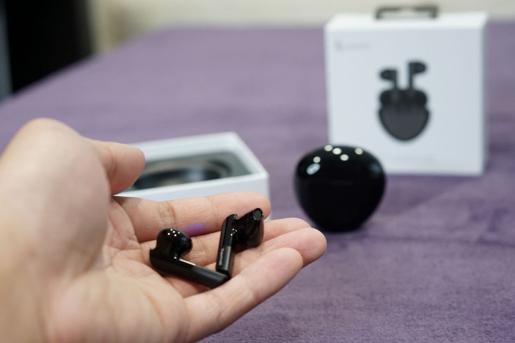 hand holding Edifier earbuds