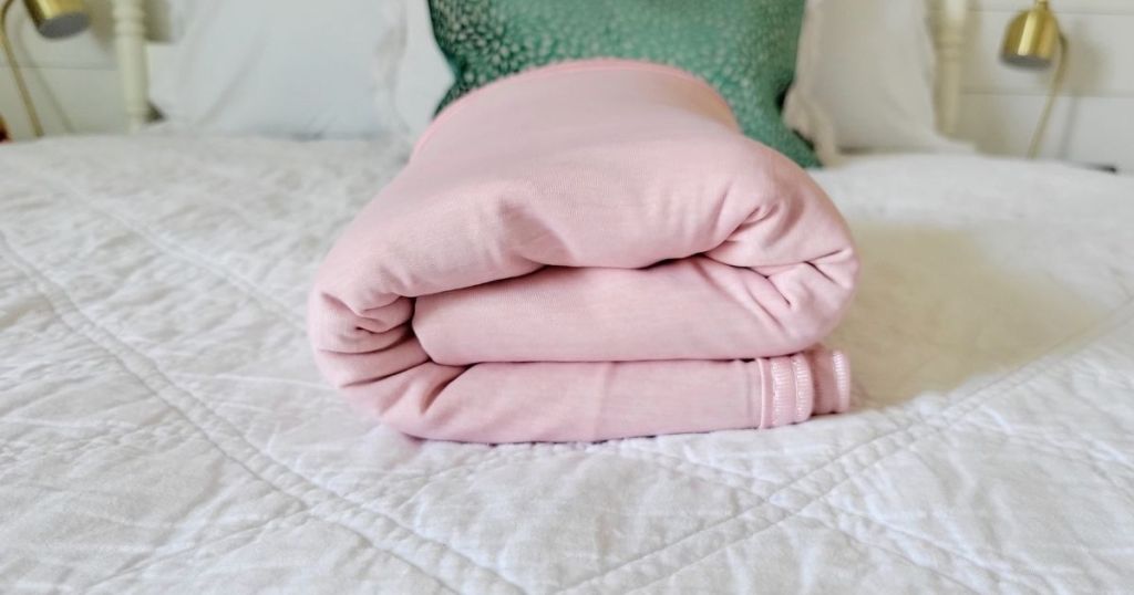pink cooling blanket folded on bed
