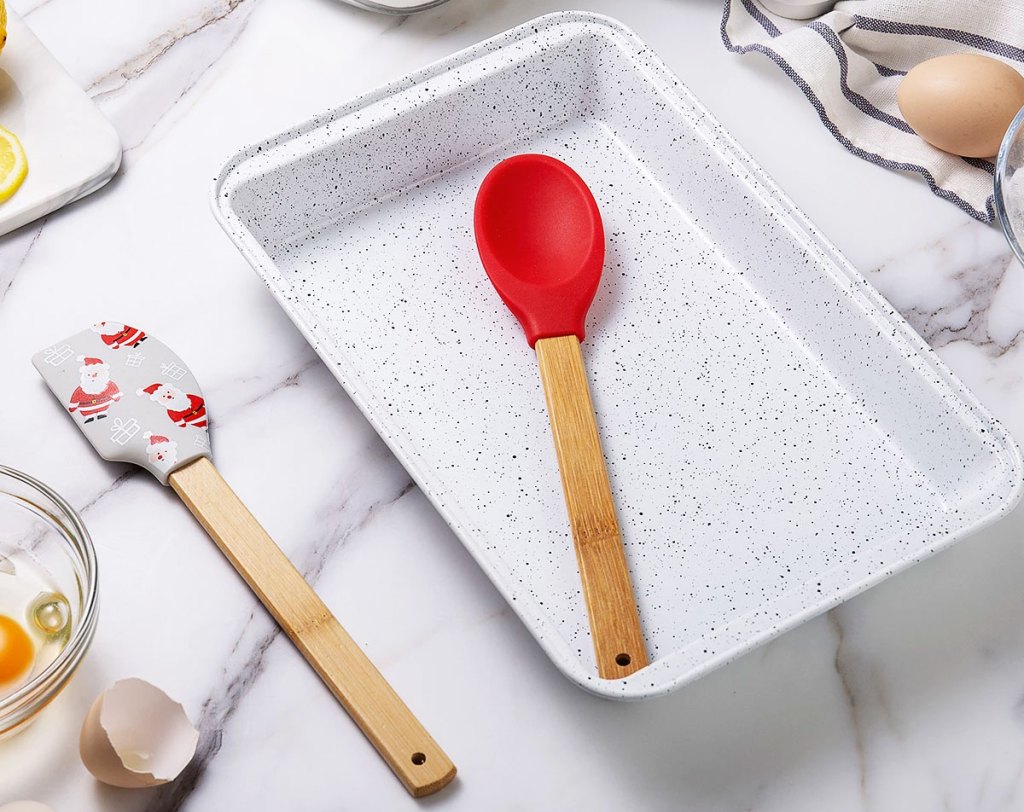 red and santa print spatulas with baking pan