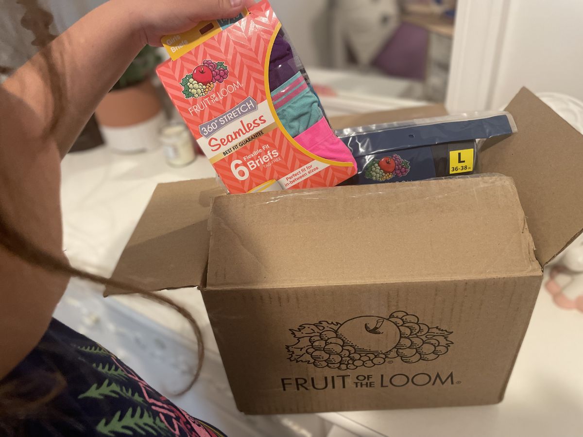 girl taking pack of undies from Fruit of the Loom box