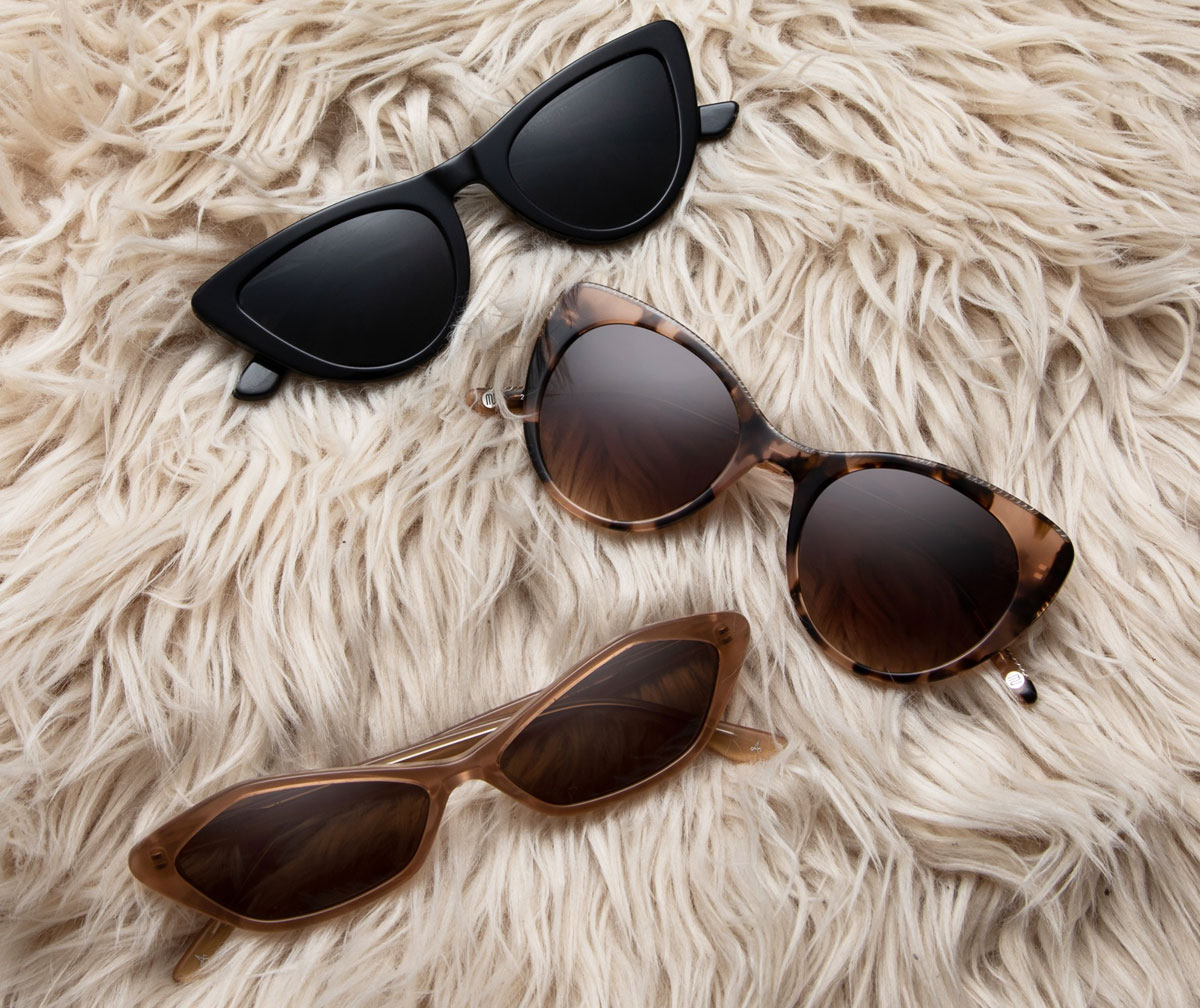 three pairs of glassesusa sunglasses on fuzzy blanket