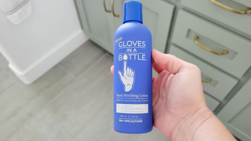 hand holding a bottle of Gloves in a Bottle