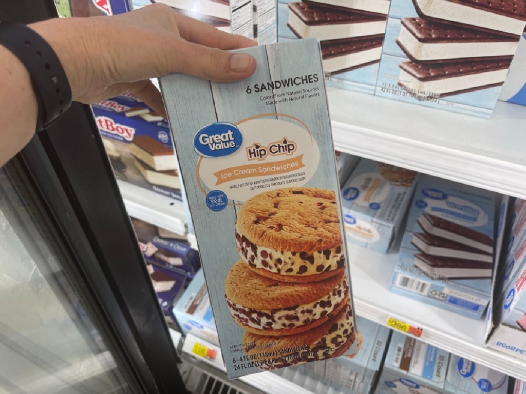 A hand pulling out a cookie dessert from the Walmart freezer
