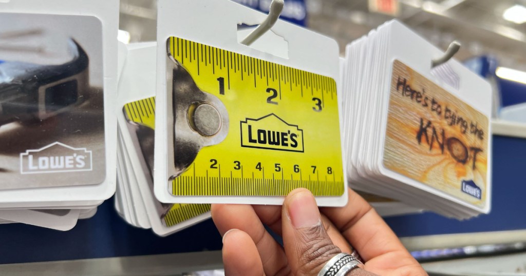 Hand grabbing Lowe's Gift Cards