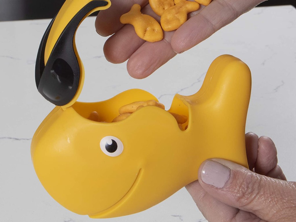 Hand pouring goldfish into goldfish snack container