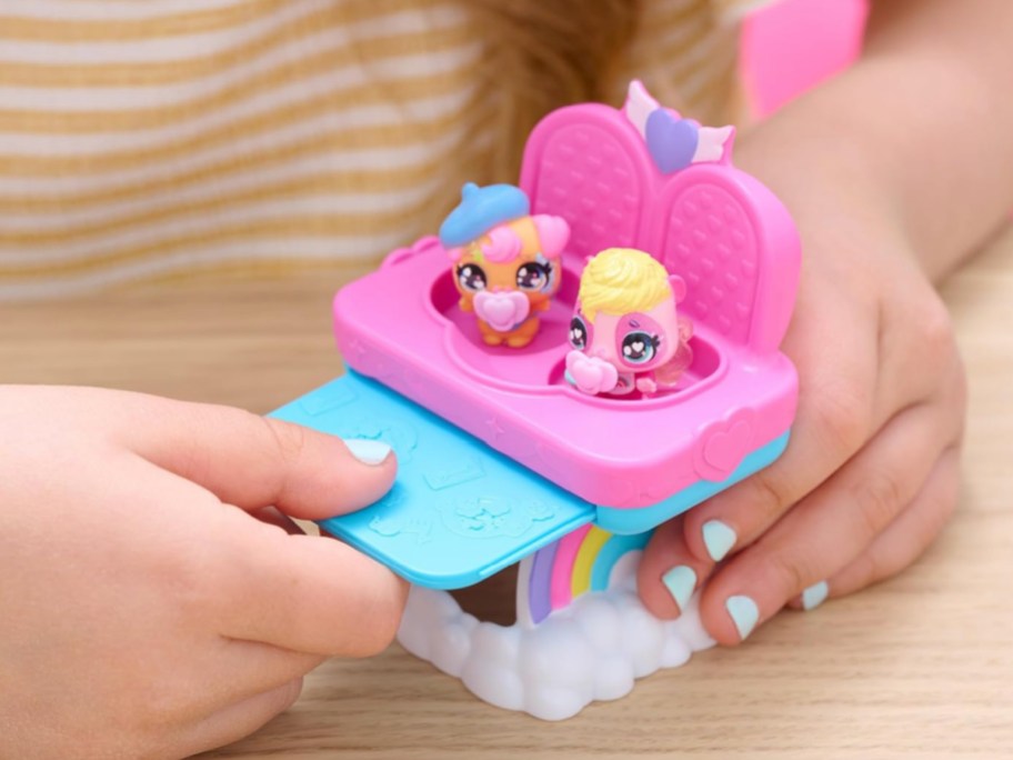 girl playing with Hatchimals Alive Figures in highchair