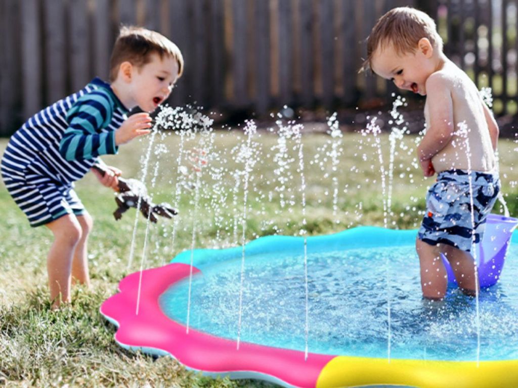 Two small boys playing on a jasonwell multicolor splash pad