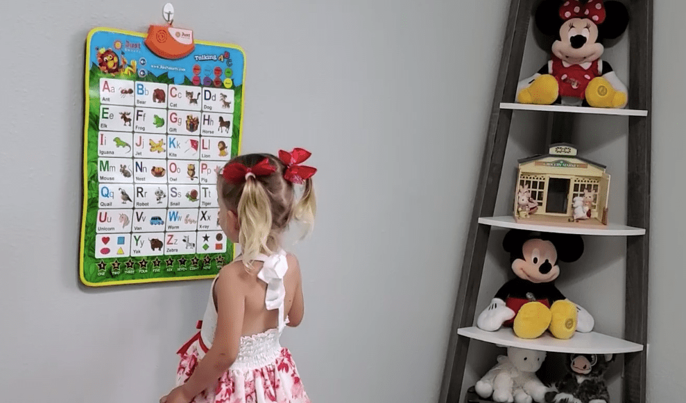 girl playing with a Just Smarty poster