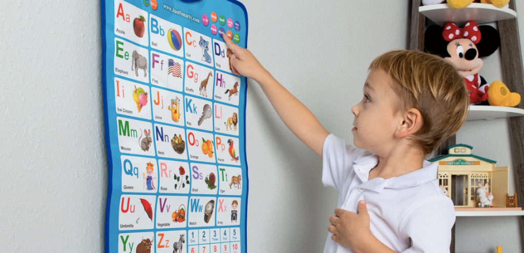 boy playing with a Just Smarty Wall Chart