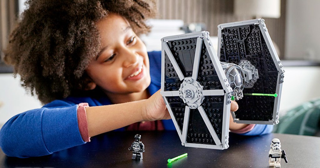 boy playing with LEGO Star Wars Imperial TIE Fighter Building Kit