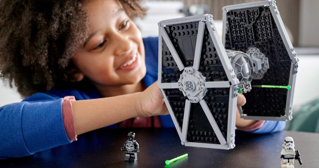 child playing with LEGO Star Wars Fighter Building Kit