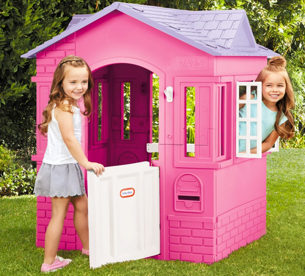 two girls playing with pink and purple playhouse