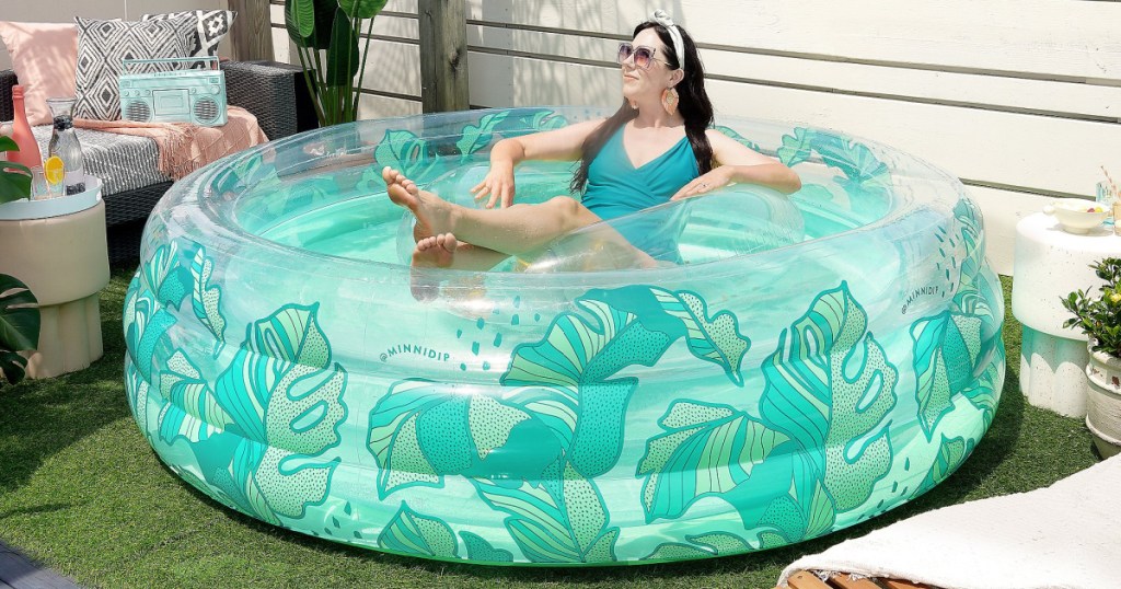 woman lounging in large inflatable pool on rooftop