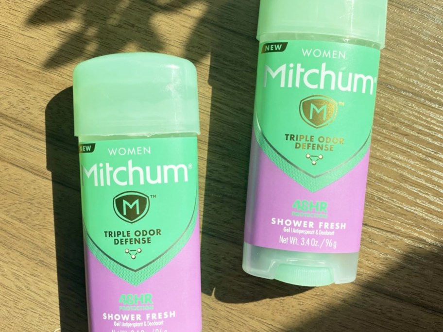 two green and purple sticks of Mitchum Deodorant