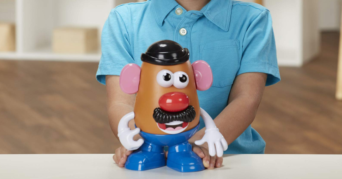 boy holding Mr. Potato Head toy